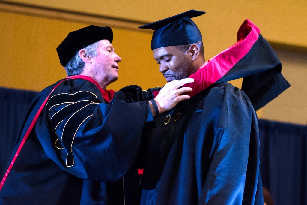 The “hooding” of Andrew Smellie as he receives his Master’s Degree!